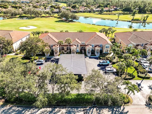an aerial view of residential houses with outdoor space and swimming pool