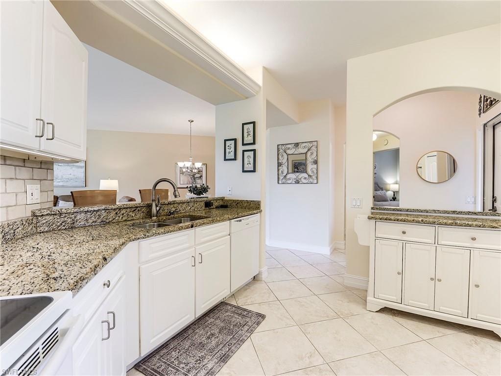 9040 Spring Run Boulevard, Unit 404 Estero, FL 34135 - Photo 13 of 34 a bathroom with a sink and a mirror