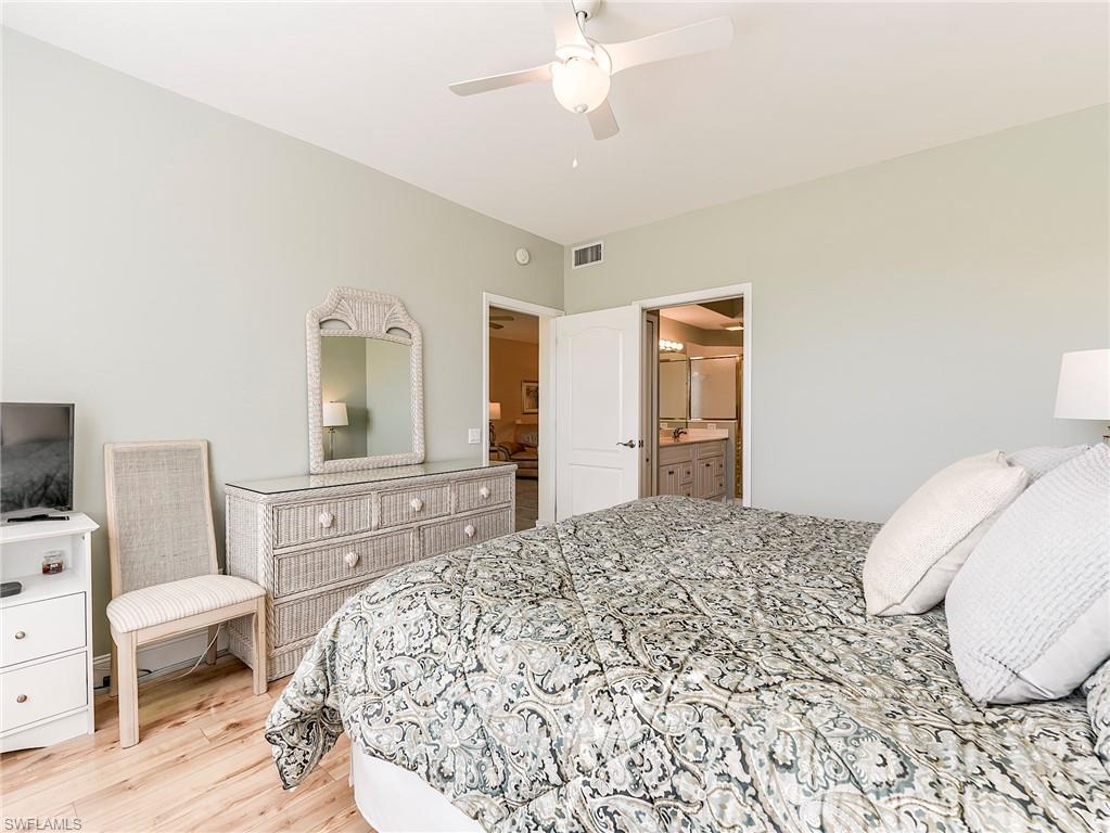 9040 Spring Run Boulevard, Unit 404 Estero, FL 34135 - Photo 16 of 34 a bedroom with a bed and a dresser in it