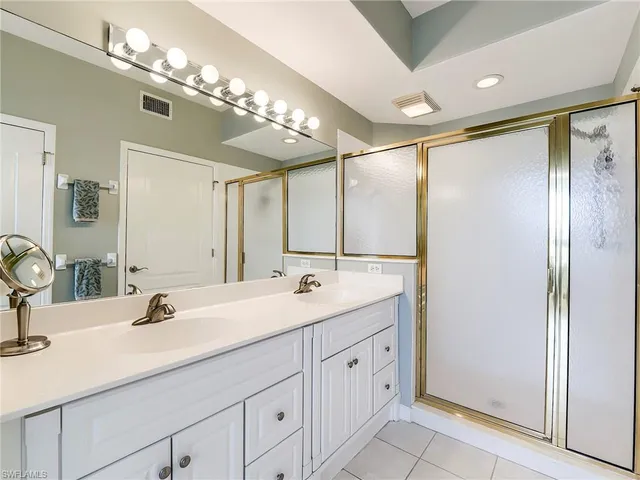 a bathroom with a double vanity sink and a mirror