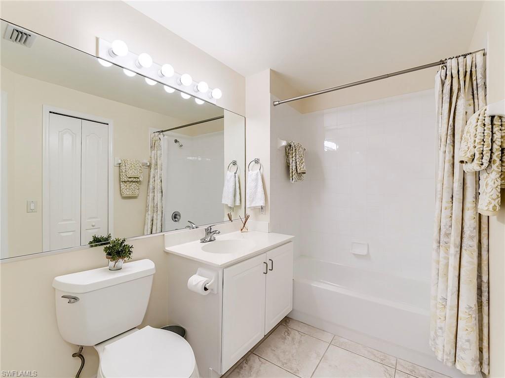 9040 Spring Run Boulevard, Unit 404 Estero, FL 34135 - Photo 20 of 34 a bathroom with a sink toilet a mirror and shower