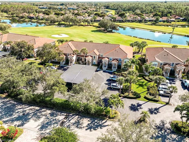 an aerial view of residential houses with outdoor space and swimming pool