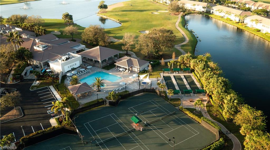 9040 Spring Run Boulevard, Unit 404 Estero, FL 34135 - Photo 28 of 34 an aerial view of a house with a yard wooden table and chairs