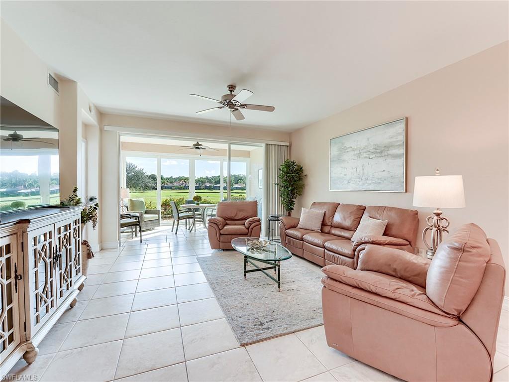 9040 Spring Run Boulevard, Unit 404 Estero, FL 34135 - Photo 4 of 34 a living room with furniture and a flat screen tv