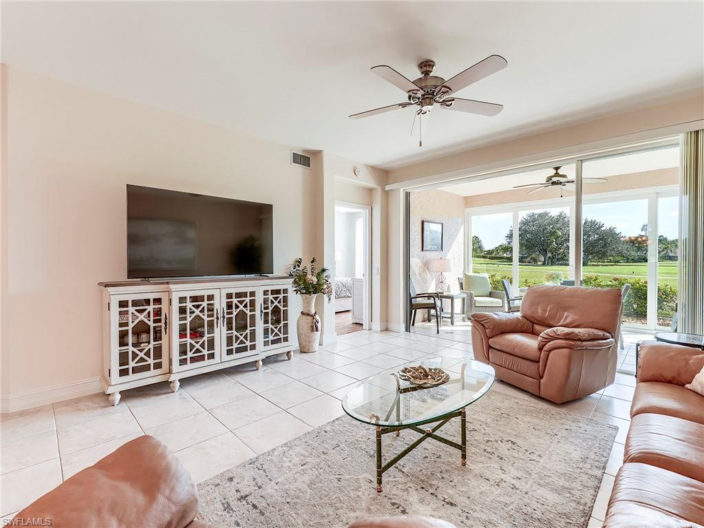 9040 Spring Run Boulevard, Unit 404 Estero, FL 34135 - Photo 6 of 34 a living room with furniture and a flat screen tv