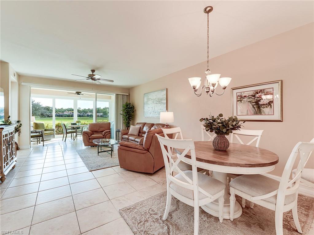 9040 Spring Run Boulevard, Unit 404 Estero, FL 34135 - Photo 8 of 34 a dining room filled with furniture and a chandelier