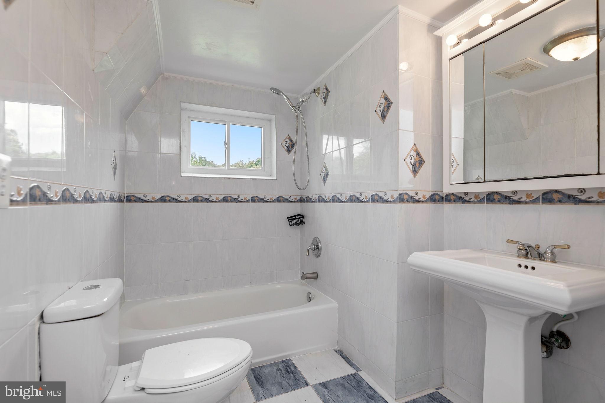 11325 Bacon Race Road Woodbridge, VA 22192 - Photo 45 of 54 a bathroom with a sink a toilet and bathtub