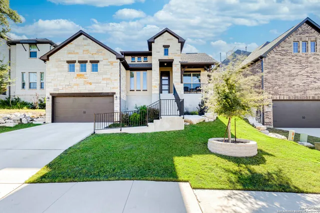 a front view of a house with a yard and a garage