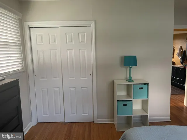 a view of room with window and wooden floor