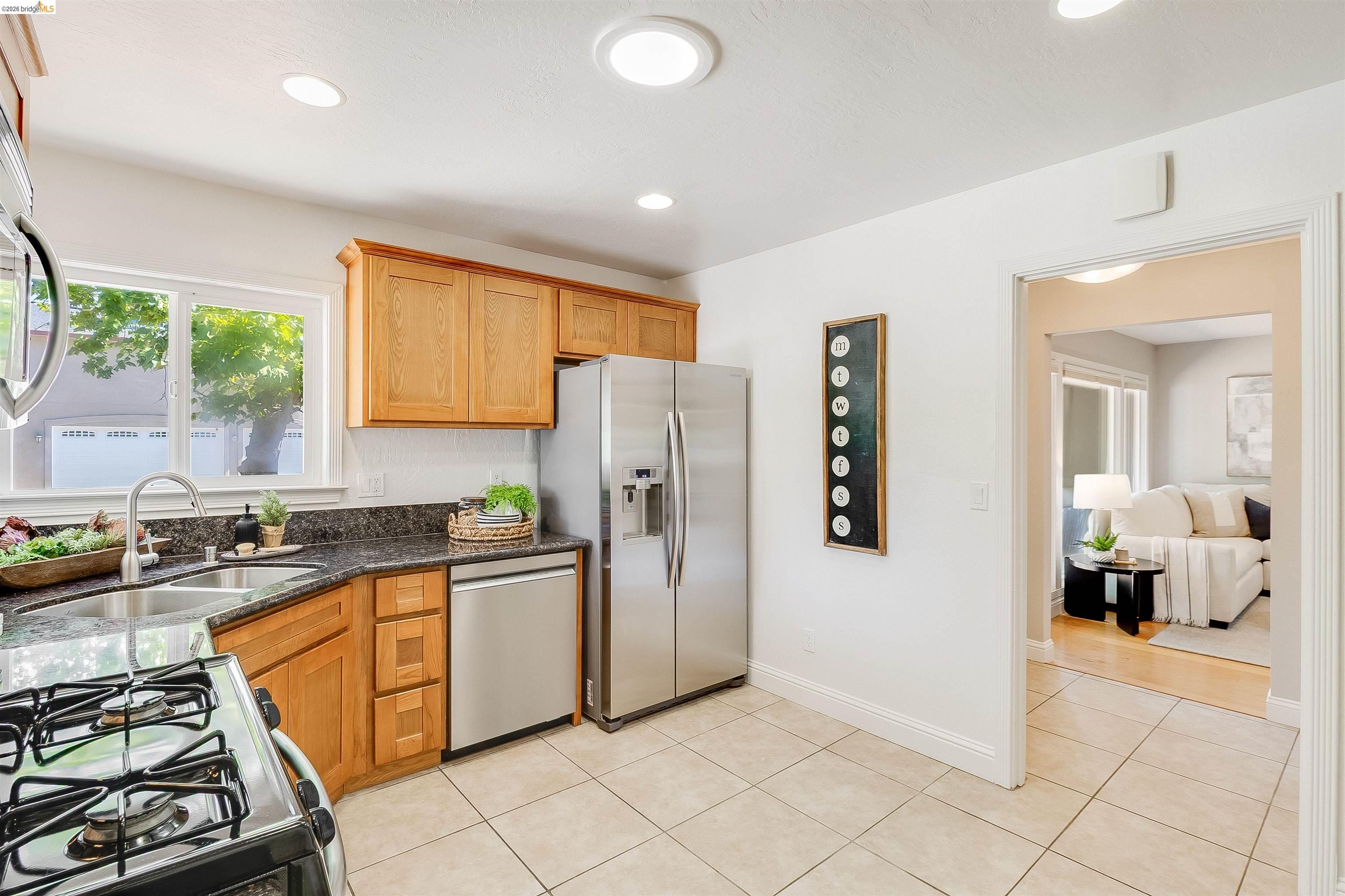 346 Valley View Road Pleasant Hill, CA 94523 - Photo 17 of 57 Kitchen featuring granite countertops, stainless steel appliances, wood cabinetry, tile flooring, and recessed lighting