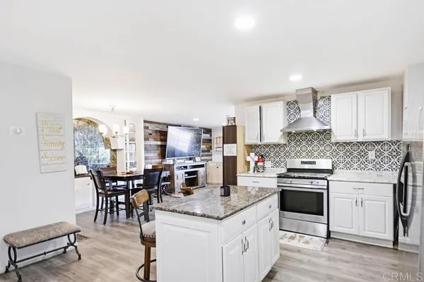 a kitchen with cabinets appliances and a counter space