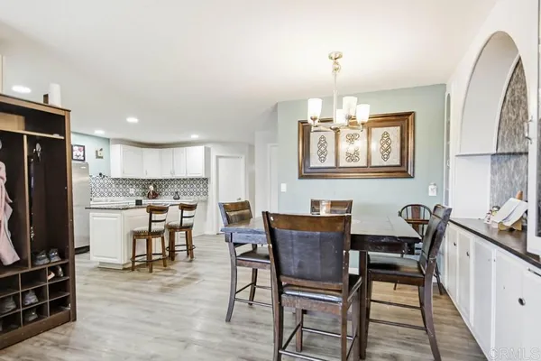 a view of a workspace with furniture and wooden floor