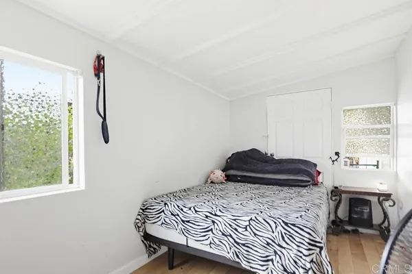 a bedroom with a bed and a window