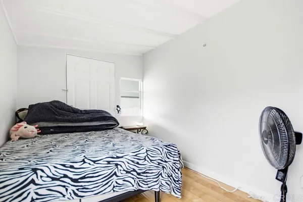 a bedroom with furniture and a flat screen tv