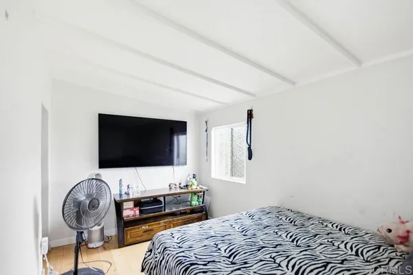 a bedroom with a bed and window