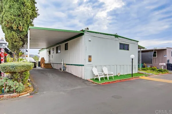a living room with furniture ceiling fan and a window