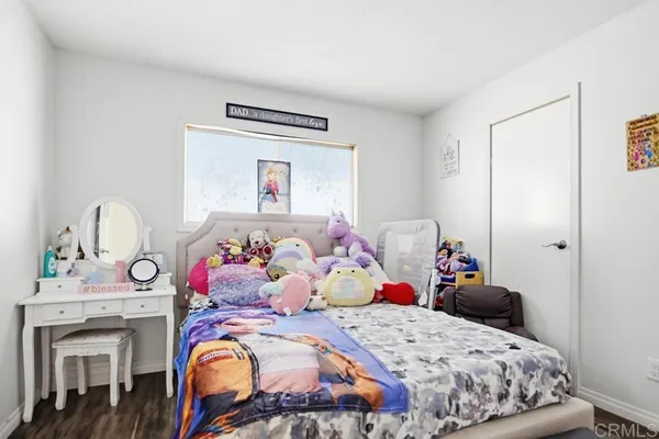 a bedroom with a bed and flat screen tv