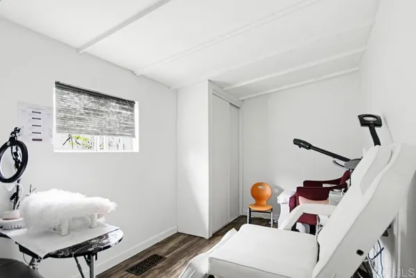 a view of a patio with chairs and wooden floor