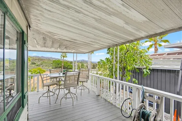 a view of a chairs and table in backyard of a house