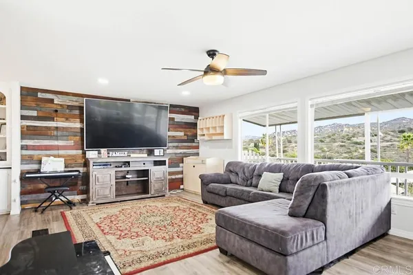a dining room with furniture a rug and a floor to ceiling window