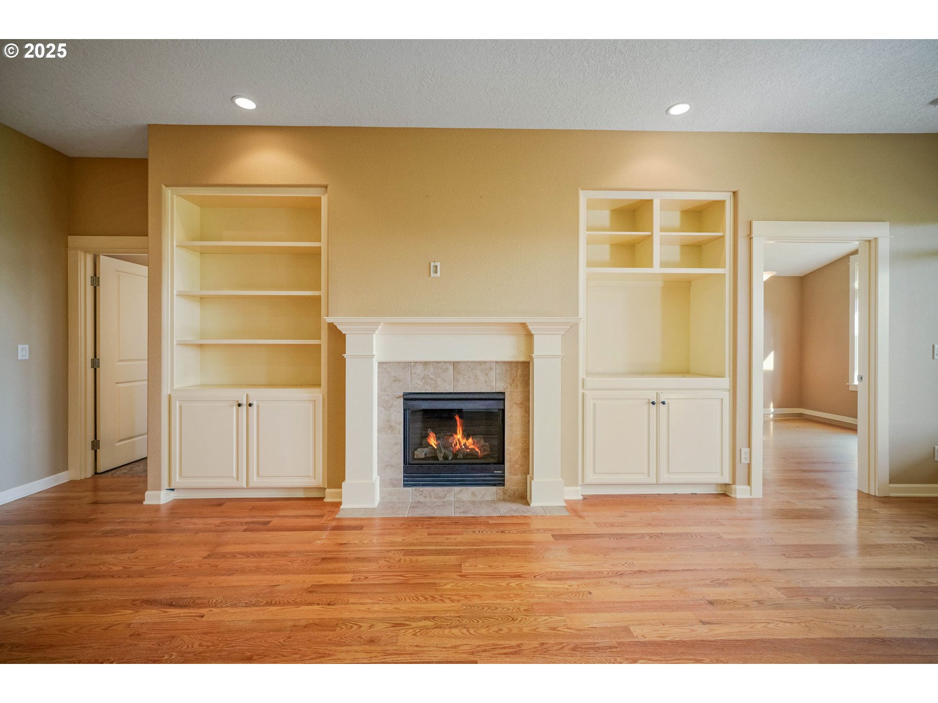 736 Southeast St Andrews Lane Dallas, OR 97338 - Photo 18 of 35 a view of an empty room with wooden floor and a fireplace