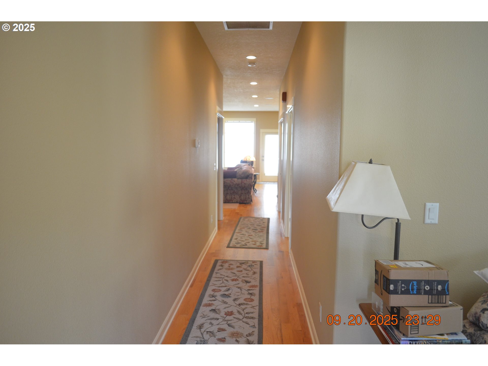 736 Southeast St Andrews Lane Dallas, OR 97338 - Photo 2 of 35 a view of a hallway with wooden floor and a bathroom