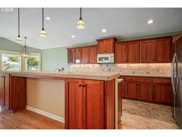 a kitchen with granite countertop wooden cabinets a sink and dishwasher