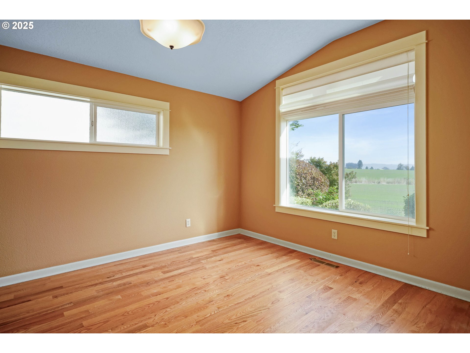 736 Southeast St Andrews Lane Dallas, OR 97338 - Photo 27 of 35 a view of an empty room with wooden floor and a window