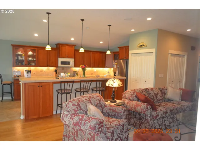 a living room with a sink and kitchen view