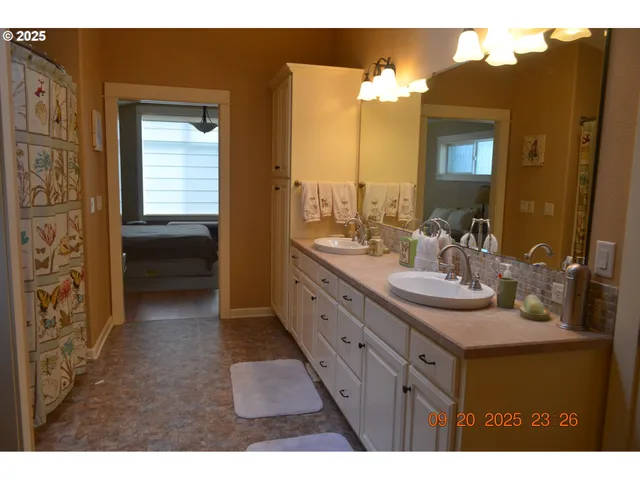 a bathroom with a double vanity sink and a mirror