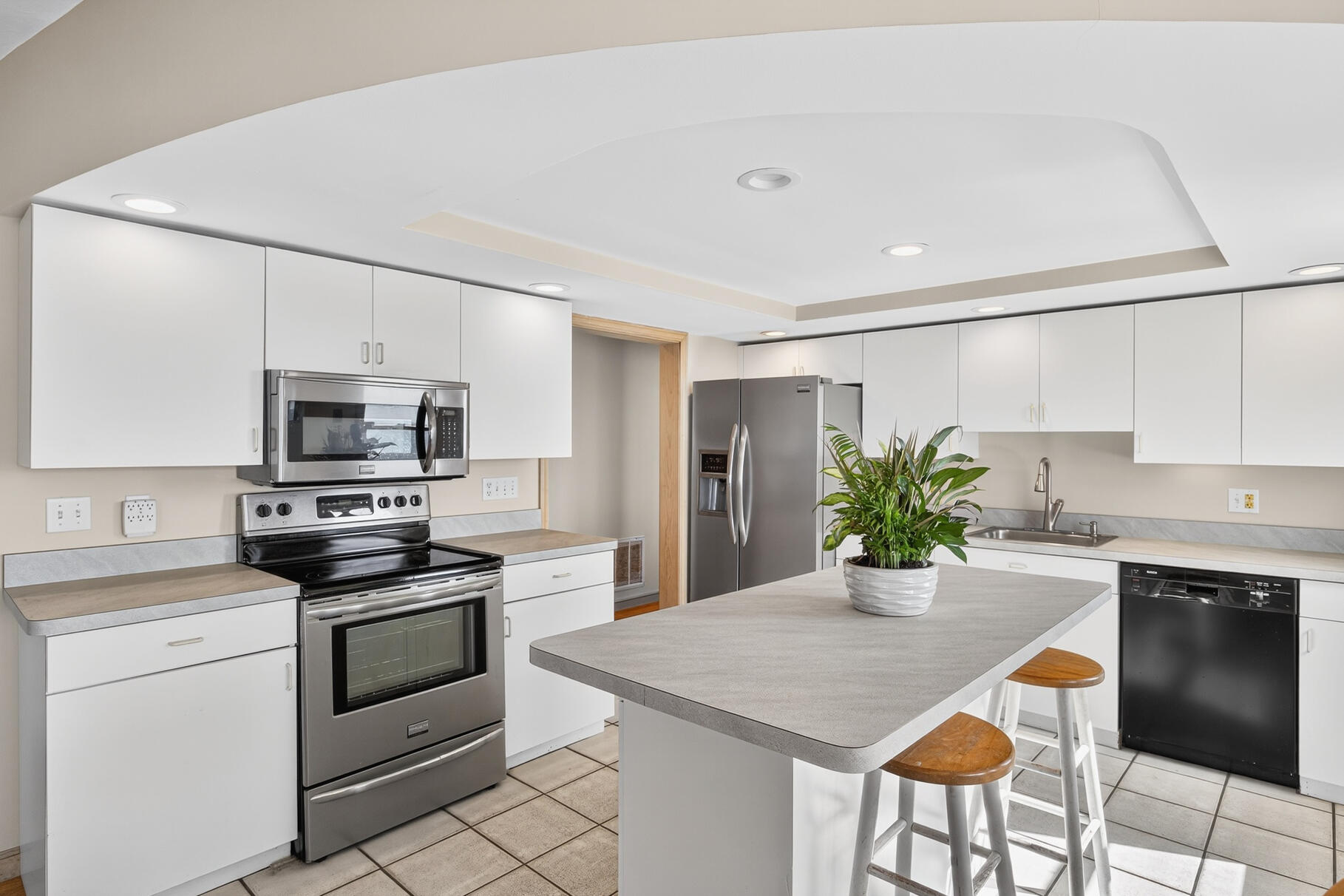 61 Menauhant Road East Falmouth, MA 02536 - Photo 17 of 65 a kitchen with a stove a sink and a refrigerator