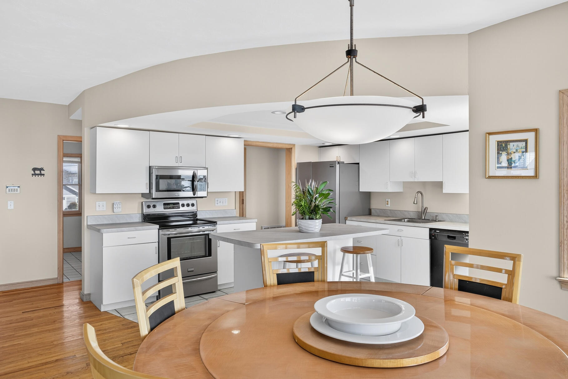 61 Menauhant Road East Falmouth, MA 02536 - Photo 18 of 65 a kitchen with stainless steel appliances granite countertop a sink a stove a refrigerator cabinets and chairs