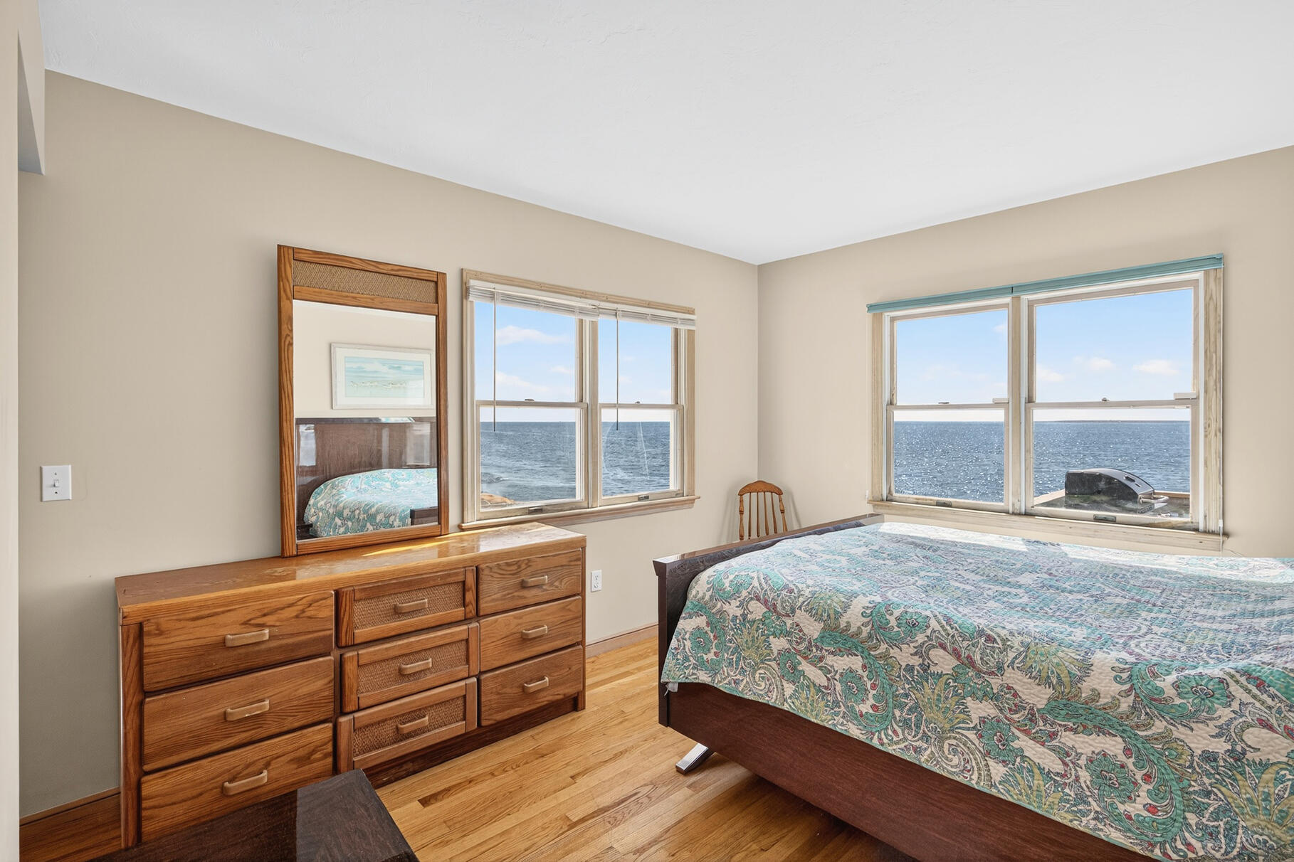 61 Menauhant Road East Falmouth, MA 02536 - Photo 26 of 65 a bedroom with a bed and large windows