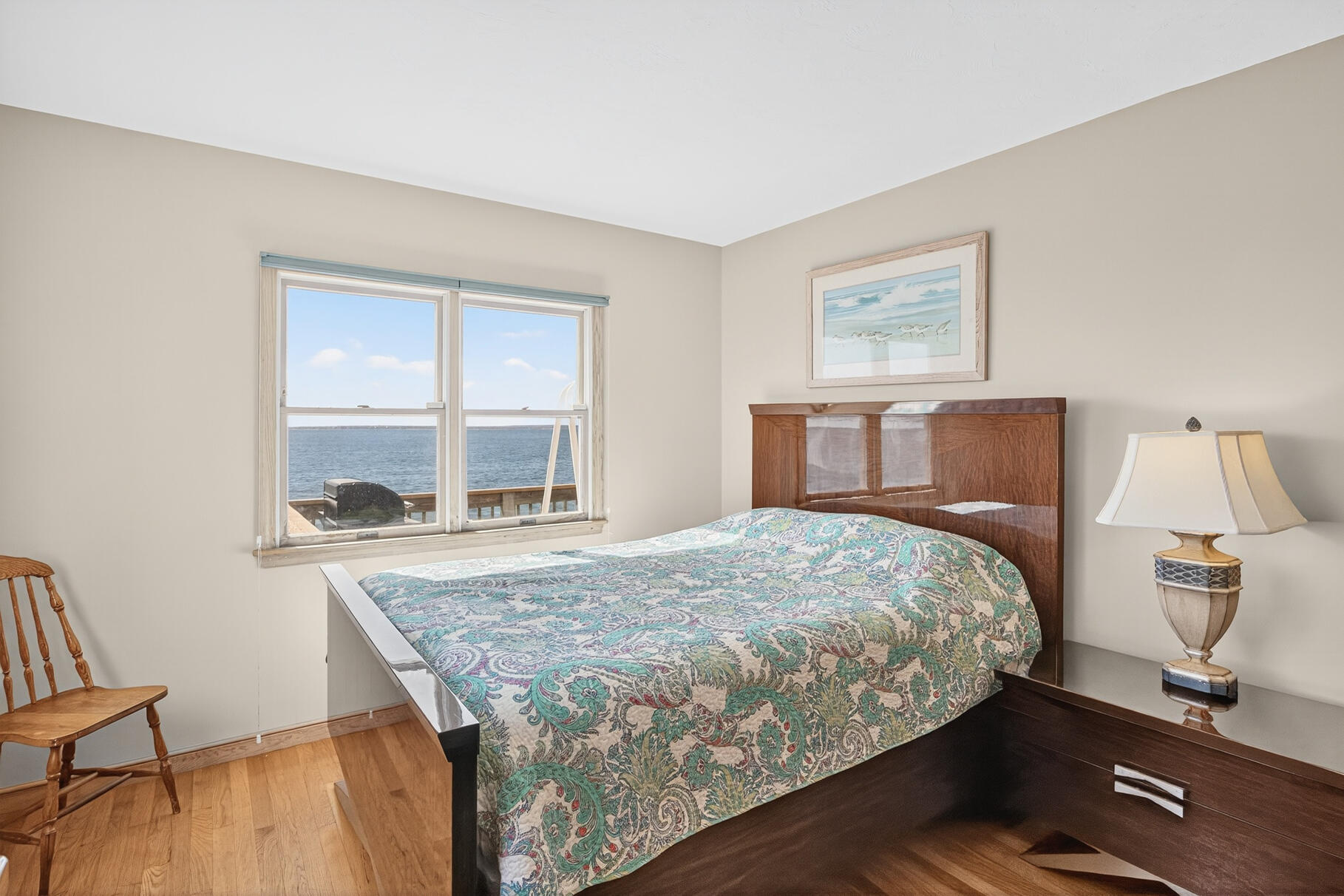 61 Menauhant Road East Falmouth, MA 02536 - Photo 27 of 65 a bedroom with a bed and wooden floor