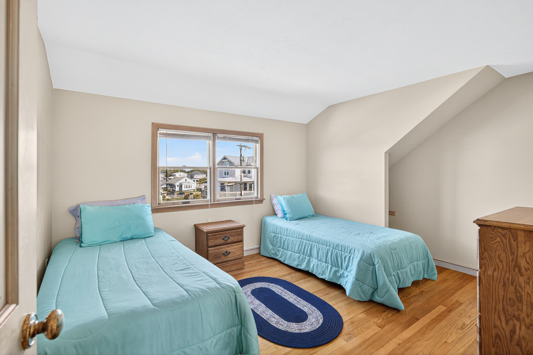 61 Menauhant Road East Falmouth, MA 02536 - Photo 32 of 65 a bedroom with two beds and a window