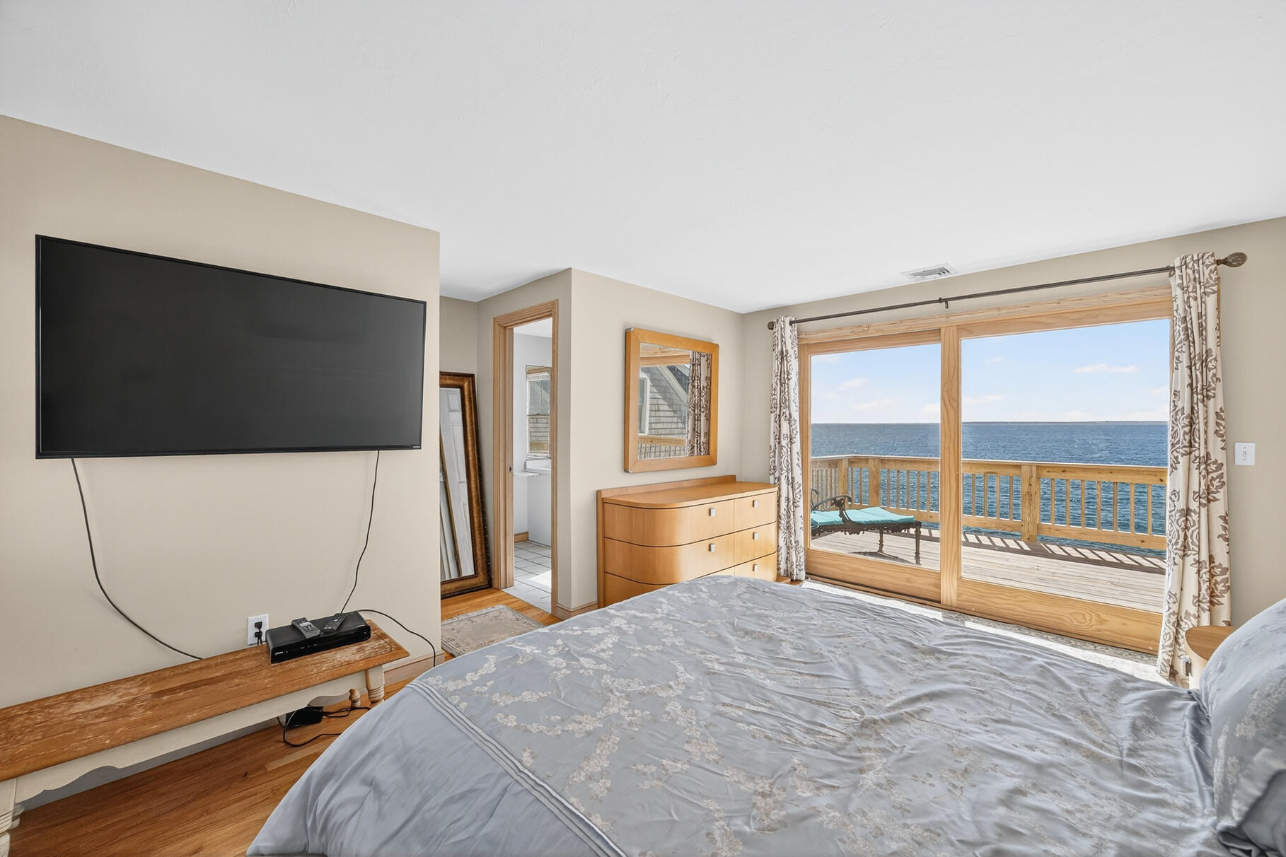 61 Menauhant Road East Falmouth, MA 02536 - Photo 39 of 65 a bedroom with a bed and a flat screen tv