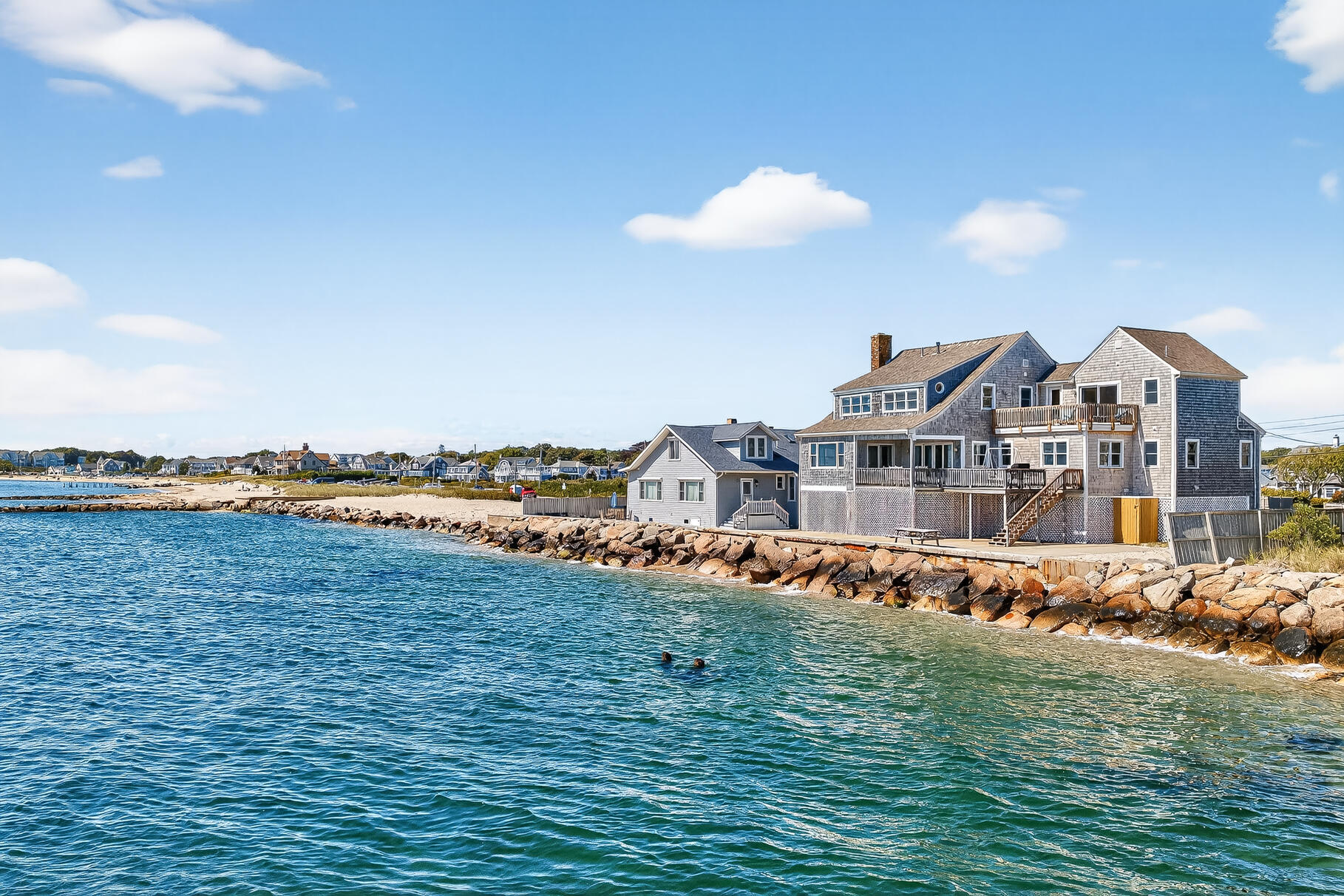 61 Menauhant Road East Falmouth, MA 02536 - Photo 7 of 65 a view of a lake with a building in the background