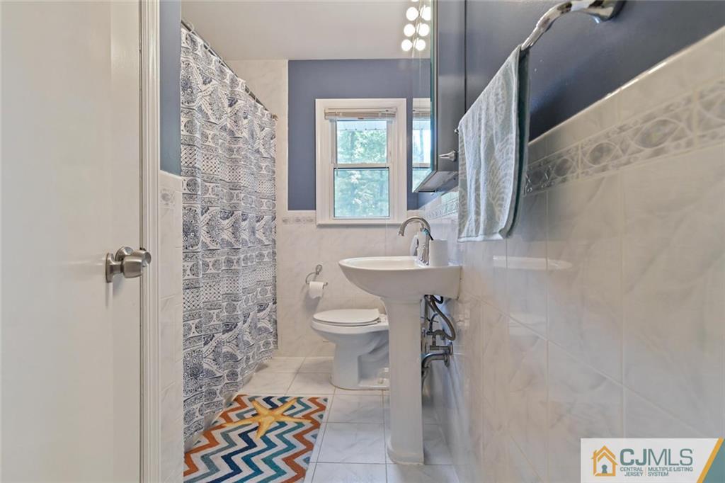 18 Tamarack Road Edison, NJ 08820 - Photo 12 of 25 a bathroom with a sink toilet and shower
