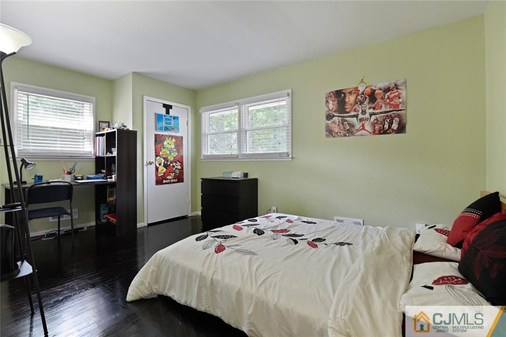 18 Tamarack Road Edison, NJ 08820 - Photo 14 of 25 a bedroom with a bed and wooden floor