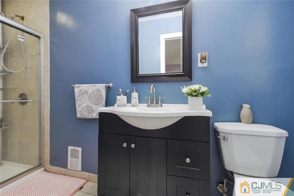 18 Tamarack Road Edison, NJ 08820 - Photo 16 of 25 a bathroom with a sink and a toilet