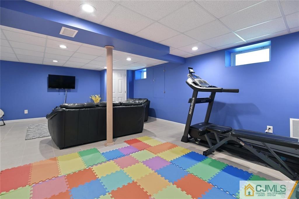 18 Tamarack Road Edison, NJ 08820 - Photo 19 of 25 a room with furniture and a flat screen tv