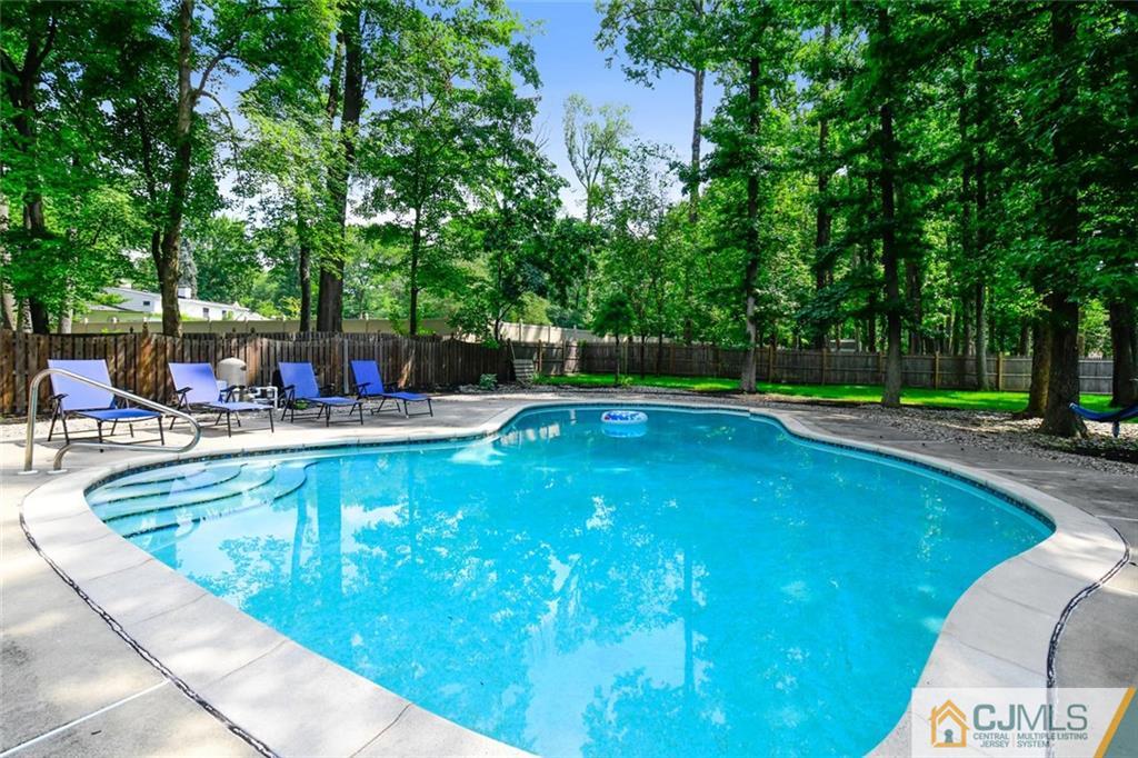 18 Tamarack Road Edison, NJ 08820 - Photo 21 of 25 a swimming pool with outdoor seating and yard