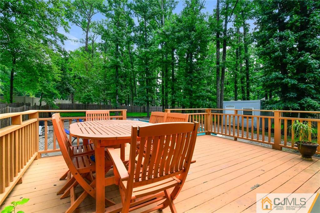 18 Tamarack Road Edison, NJ 08820 - Photo 22 of 25 a roof deck with table and chairs wooden floor and fence
