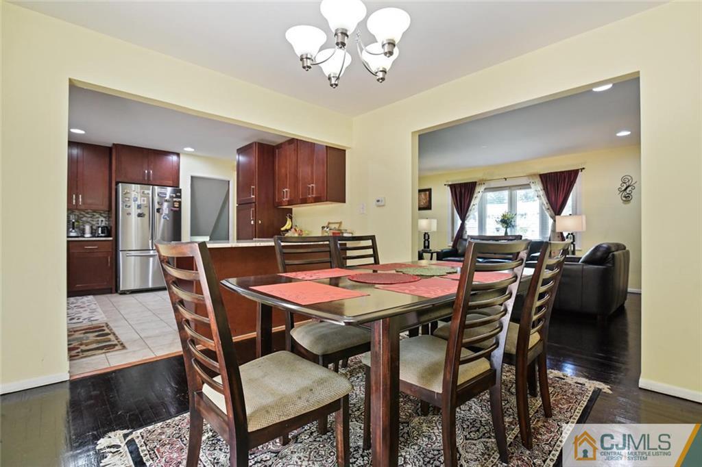 18 Tamarack Road Edison, NJ 08820 - Photo 5 of 25 a dining room with a wooden table and chairs