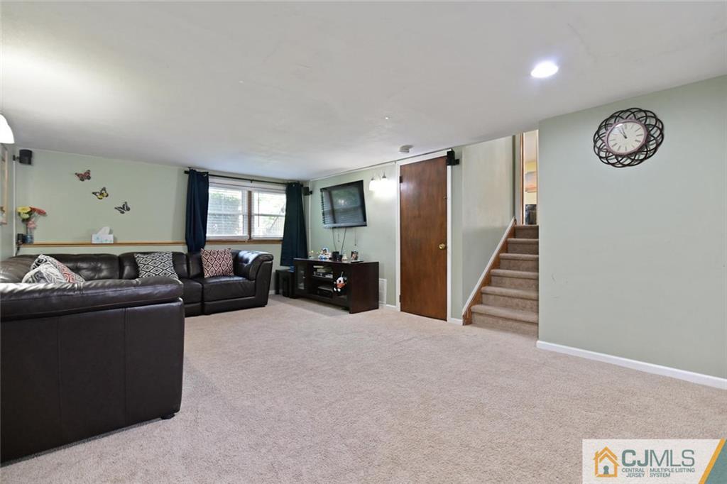 18 Tamarack Road Edison, NJ 08820 - Photo 10 of 25 a living room with furniture and a clock