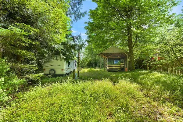 a backyard of a house with a garden and tree