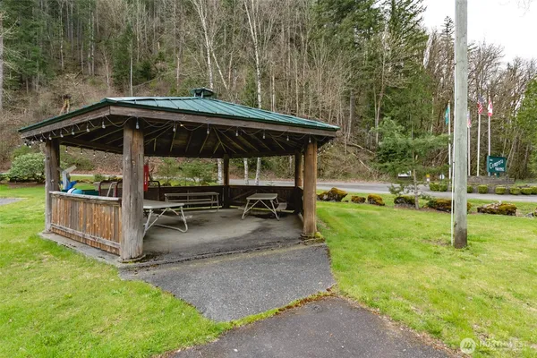 a view of outdoor space table and chairs under an umbrella