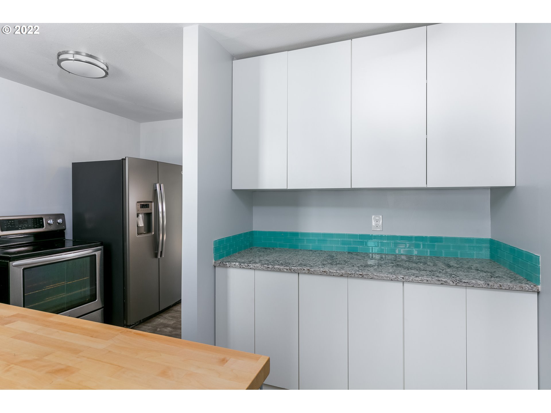 205 Southwest Ruckel Street Cascade Locks, OR 97014 - Photo 8 of 24 a kitchen with stainless steel appliances granite countertop a refrigerator a stove and a sink