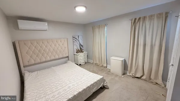 a bedroom with a bed and chair