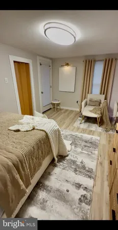 a bed sitting in a spacious bedroom next to a window